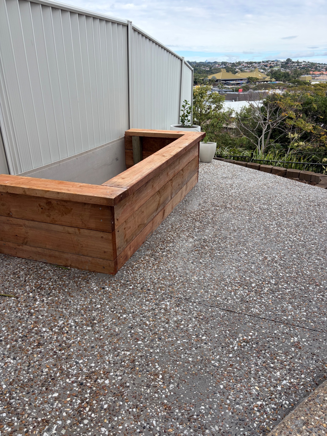 Custom hardwood planter box built into a corner on a gravel terrace with views over the Tweed Coast
